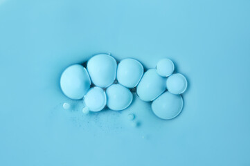 Blue floating bubbles on an oil basis. Acrylic paint. Abstract background.