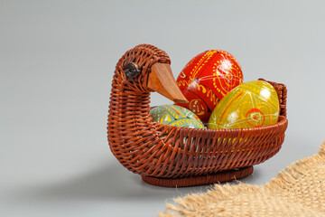 Painted Easter eggs in the wicker basket.