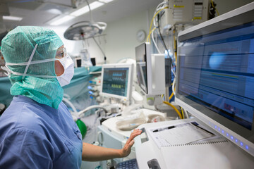 Female doctor examining medical reports on computer while working in hospital