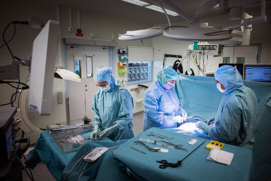 Doctors doing surgery of patient with medical equipment in operation theater at hospital