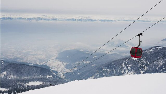 Gondola Cable Car Moving Uphill On Snowy Apharwat Summit In Gulmarg, India. high angle, static shot