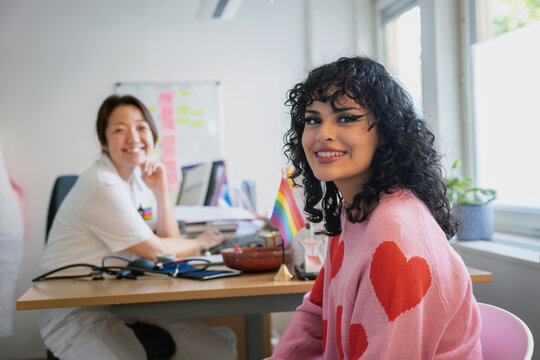 Portrait of female doctor and teenage girl sitting in clinic