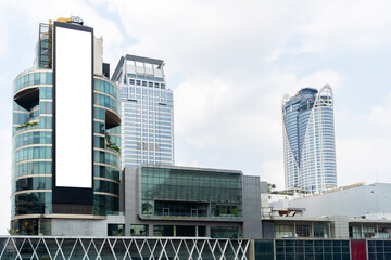 Large white billboard on the side of a building in Bangkok, Thailand. Billboard is located in a...