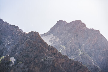 Fototapeta premium View of the mountain ranges and peaks of the Fan Mountains with glaciers, rocks and vegetation in Tajikistan, mountain panorama on a summer sunny day