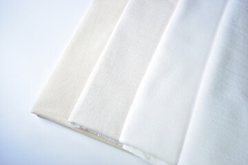 stack of white cotton clothes, pile of clothing on white background