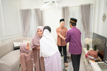 Portrait of two Muslim families forgiving each other when Idul Fitri or Eid al Fitr.