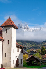 Fototapeta na wymiar village of Duingt in the Alps, snow-capped mountain in background