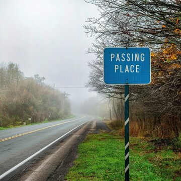 Passing place sign on a rural road in a misty day