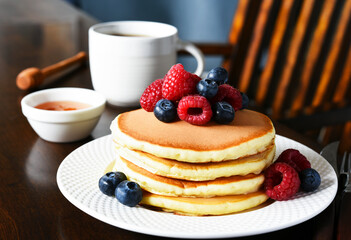 Pancakes with raspberries and blueberries with honey. Morning,pancakes for breakfast