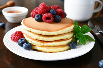 Pancakes with raspberries and blueberries with honey. Morning,pancakes for breakfast
