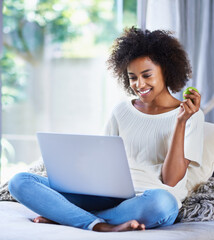 Apple, fresh produce and woman on sofa with laptop for social media, lifestyle blog and food...