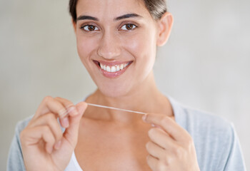 Woman, portrait and happy with dental floss in home for health, wellness or care for teeth in morning. Girl, person and smile with string for oral, mouth or cleaning for hygiene at apartment in Chile