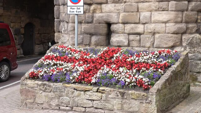 British National Flag Made of Flowers in Front of Entrance Gate of Alnwick Town, England UK