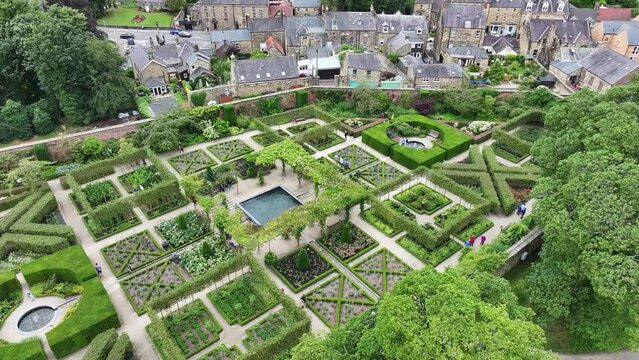 Alnwick Garden, England UK. Drone Shot of Green Gardens and Fountain in Medieval Park