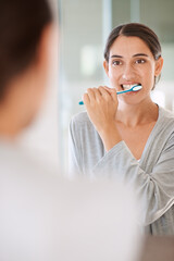 Woman, brushing teeth and smile in home by mirror for health, wellness or self care for breath in morning. Girl, person and happy with toothbrush, mouth and cleaning for hygiene at apartment in Chile - obrazy, fototapety, plakaty
