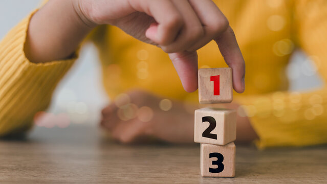 Wooden cubes with numbers first, second, and third. Task priority and management concept. The order of priority in any activity. Set work priority.