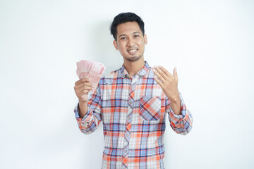 Adult Asian man smiling happy at camera while holding money