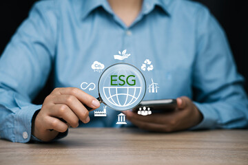 ESG concepts regarding environment, society and governance. Green icon on wooden block Sustainable...