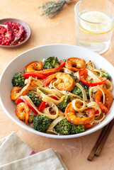 Udon noodles with shrimp, broccoli and peppers. Asian cuisine.