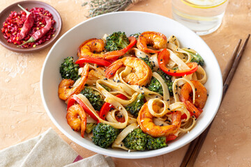Udon noodles with shrimp, broccoli and peppers. Asian cuisine.