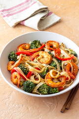 Udon noodles with shrimp, broccoli and peppers. Asian cuisine.