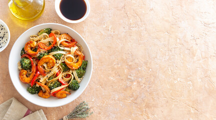 Udon noodles with shrimp, broccoli and peppers. Asian cuisine.