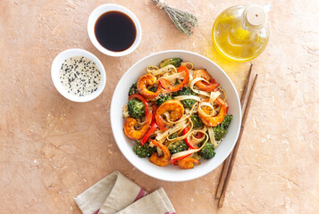 Udon noodles with shrimp, broccoli and peppers. Asian cuisine.