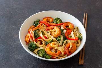 Udon noodles with shrimp, broccoli and peppers. Asian cuisine.