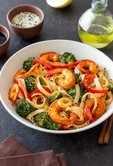 Udon noodles with shrimp, broccoli and peppers. Asian cuisine.