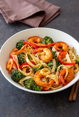 Udon noodles with shrimp, broccoli and peppers. Asian cuisine.