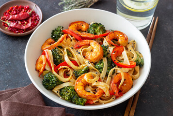 Udon noodles with shrimp, broccoli and peppers. Asian cuisine.