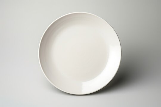 A simple white plate on a table, versatile for various concepts
