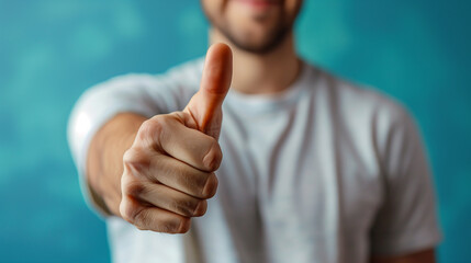 Close up man in a light shirt showing thumbs up gesture on a pastel blue background - obrazy, fototapety, plakaty