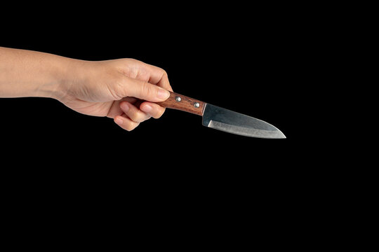 Hand and knife on a black background 