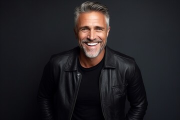Portrait of a smiling mature man in a black leather jacket.