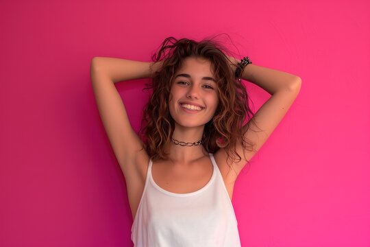 A woman with curly hair is smiling and posing for a picture