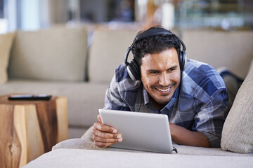 Man, headphones and tablet for music in home, website and internet for streaming. Happy male...