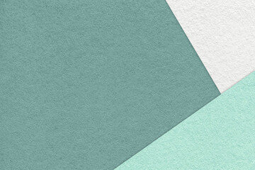 Texture of craft dark cyan color paper background with white, green and mint border. Vintage abstract cardboard.