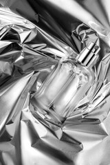 Perfume bottle on silver foil