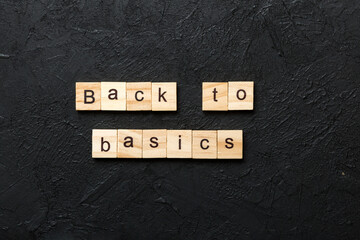 back to basics word written on wood block. back to basics text on table, concept