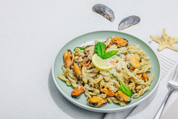 Plant based pasta with mussels, pesto and parmesan cheese. Ready to eat healthy food, served portion