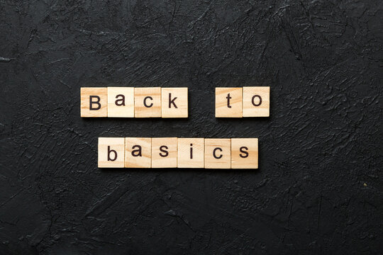 back to basics word written on wood block. back to basics text on table, concept