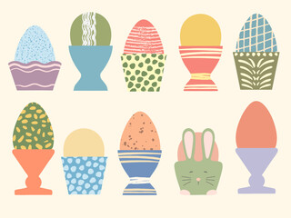 Colored Easter eggs in cute cups vector illustration set. Eggs decorated with brush strokes and dots on pastel background. Soft colors. Flat cartoon poster. Happy Easter design. Festive spring meal