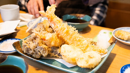 Deep fried kaki oyster tempura served with salt and lemon