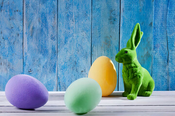 Easter decoration with green Easter bunny and three eggs