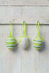 Easter eggs hanging on wall