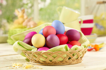 Fototapeta na wymiar Eastern, Easter nest, basket with coloured eggs