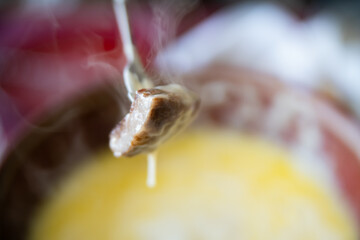 Swiss fondue made of white wine, dipping slices of Japanese beef stake and French bread.