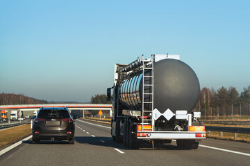 Petrol tanker truck on highway at sunset. It delivers fuel and gas.