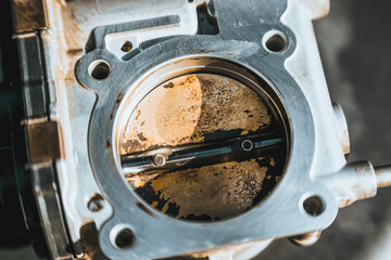 A dirty throttle valve in a car engine that needs to be cleaned and calibrated for better...